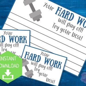 May include: White printable cards with the text "Your HARD WORK will pay off! Try your best!" and a dumbbell graphic. One card has a green "INSTANT DOWNLOAD" icon. The cards are on a blue wooden background.