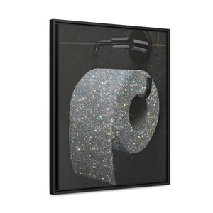 May include: A framed art print featuring a roll of glitter-covered toilet paper. The artwork is set against a dark background, with a black frame and a silver toilet paper holder. The glitter adds a sparkling, luxurious touch to the bathroom decor.