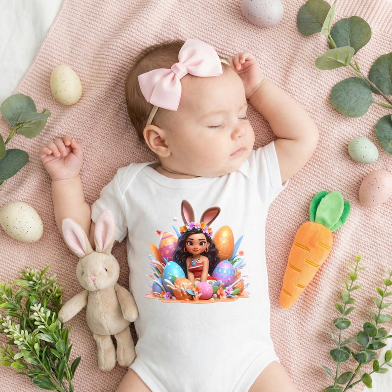 May include: A sleeping baby wearing a white onesie with an Easter-themed graphic, a pink bow, and surrounded by Easter eggs, a plush bunny, and a carrot toy. The baby is lying on a pink blanket.