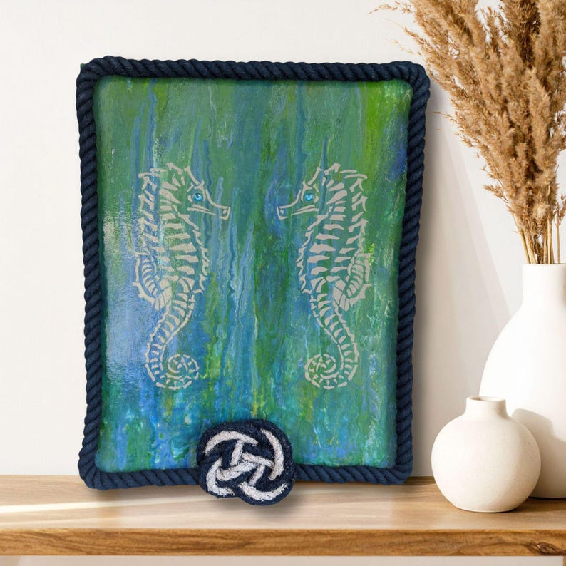original nautical painting with two seahorses on blue green poured ocean background rope frame finish jeweled turquoise eyes coastal wall art for beach house decor