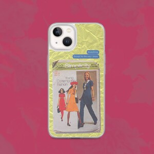 May include: A clear phone case with a yellow crumpled paper background. The case has a vintage sewing pattern on the back with three women wearing dresses. The text on the pattern reads "9502 Simplicity Young Contemporary Fashion". A blue text box on the case reads "Everything Except for the way I dress".