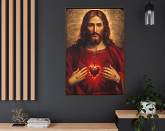 May include: A framed portrait of Jesus Christ, depicted with long brown hair and a beard, wearing a red robe. His hands are positioned near his chest, revealing a glowing heart. The background features a golden aura.