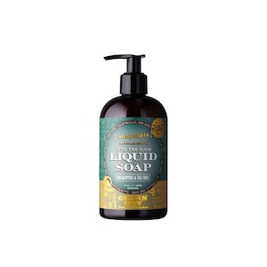 May include: A brown bottle of Soaptopia Into the Flow Liquid Soap with Eucalyptus & Tea Tree scent. The bottle has a green label with gold lettering and a gold Clean Day logo.