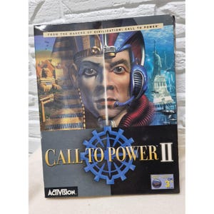 Könnte beinhalten: Eine Spielbox des Videospiels "Call to Power II". Das Cover zeigt ein geteiltes Bild eines Pharaos und einer futuristischen Figur, mit dem Spieltitel in Gold und einer blauen Zahnradgrafik. Das Activision-Logo befindet sich unten.