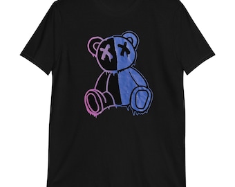 May include: Black t-shirt with a graphic of a blue and pink teddy bear with an X for eyes. The bear is dripping with paint.
