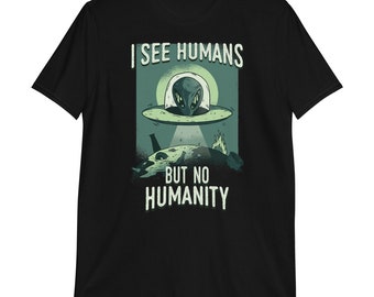 May include: Black t-shirt with a graphic of a green alien in a flying saucer over a planet. The text reads "I see humans but no humanity."