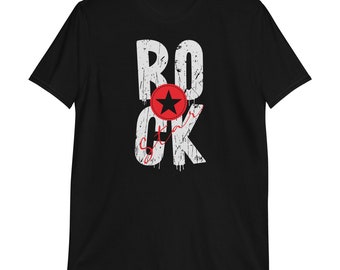 May include: Black t-shirt with a white distressed graphic that says "ROCK star" with a red star in a circle.