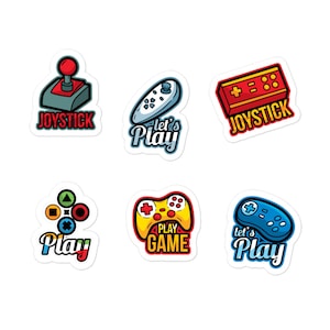May include: Six colorful stickers featuring different video game controller designs. The stickers include a red joystick, a blue controller, a yellow controller, a red and white controller, a red and white joystick, and a blue and white controller. The stickers have text that says "Let's Play", "Play Game", "Joystick", and "Play".