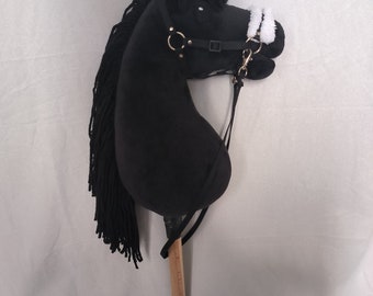 May include: Black plush rocking horse with a white fleece nose band and a brown wooden stick handle.