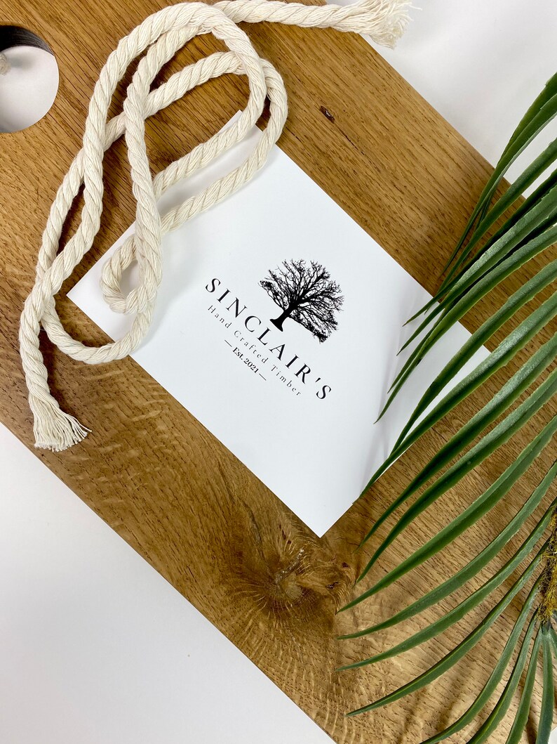 May include: A white card with black text and a tree graphic. The text reads "Sinclair's Hand Crafted Timber - Est. 2021 - "