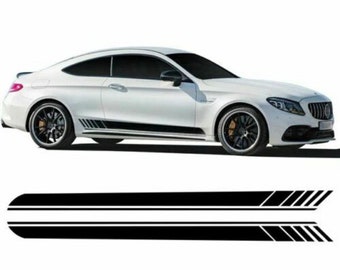May include: White sports car with black racing stripes along the side. The car has black rims and a sleek design. Below the car are two black racing stripe decals with angled accents.