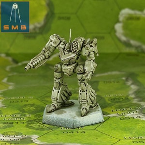 May include: A white painted miniature robot with a large gun and a missile launcher. The robot is standing on a round base with a green and brown background.