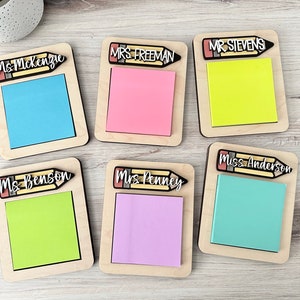 May include: Six wooden notepads with pencil toppers. Each notepad has a different teacher's name and a different colored sticky note. The names are: Ms. McKenzie, Mrs. Freeman, Mr. Stevens, Ms. Benson, Mrs. Penney, and Miss Anderson.