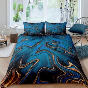 May include: A blue and gold abstract bedding set with a swirling, marbled pattern. The set includes a duvet cover and two pillowcases.