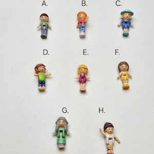 May include: Eight plastic dolls with different hairstyles and outfits. The dolls are labeled A through H.