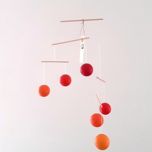 Bright shops colors handmade hanging mobile made from beech wood and colored with eco friendly paint.