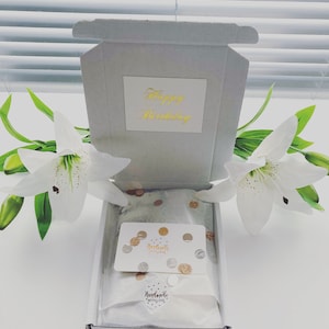 May include: A white gift box with a gold inscription that reads "Happy Birthday". The box is open and contains a white card with gold confetti and the text "Handmade with Love".