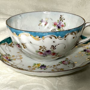 Hand Painted Fine Porcelain Antique Teacup, Multicolor Floral Sprays and Turquoise Rim on a Swirl Embossed Unmarked Cup and Saucer