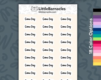 May include: A sheet of planner stickers featuring the text Game Day in a black handwritten font. The stickers are arranged in three columns on a light cream background. The top of the sheet displays the LittleBarnacles logo and website.