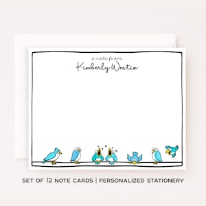 May include: White note cards with a black border, featuring a row of cartoon blue birds. The text "a note from Kimberly Westin" is at the top. The bottom of the card reads "SET OF 12 NOTE CARDS | PERSONALIZED STATIONERY".
