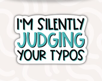 May include: A waterproof vinyl sticker featuring the text I'M SILENTLY JUDGING YOUR TYPOS in black lettering with a teal outline. The sticker has a white background and a die-cut shape that follows the contour of the bold, sans-serif typography.