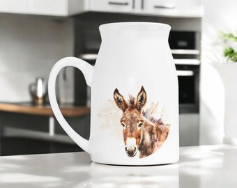 May include: White ceramic mug with a watercolor illustration of a brown and white donkey on the front. The donkey is looking directly at the viewer.