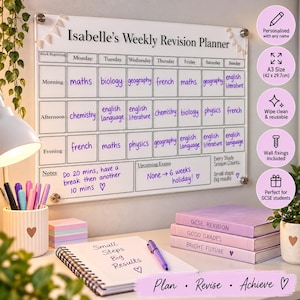 May include: A rectangular acrylic weekly revision planner wall board with black text reading Isabelle's Weekly Revision Planner, featuring a grid for morning, afternoon, and evening study sessions, notes, and upcoming exams, measuring 42 x 29.7 cm.