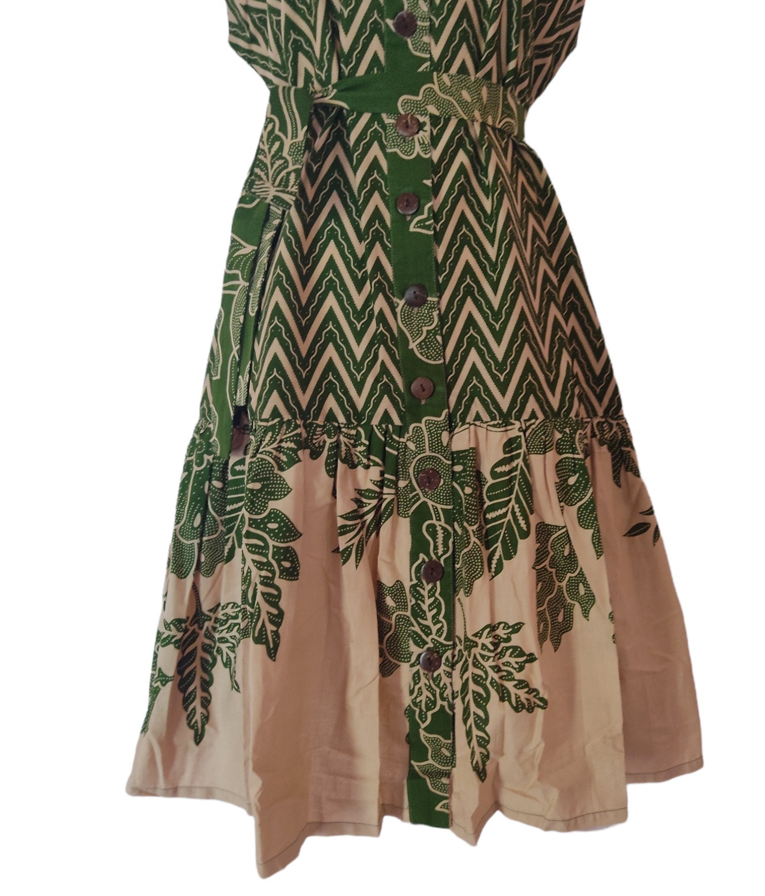 Green sleeveless batik dress for women, featuring a vibrant traditional pattern.