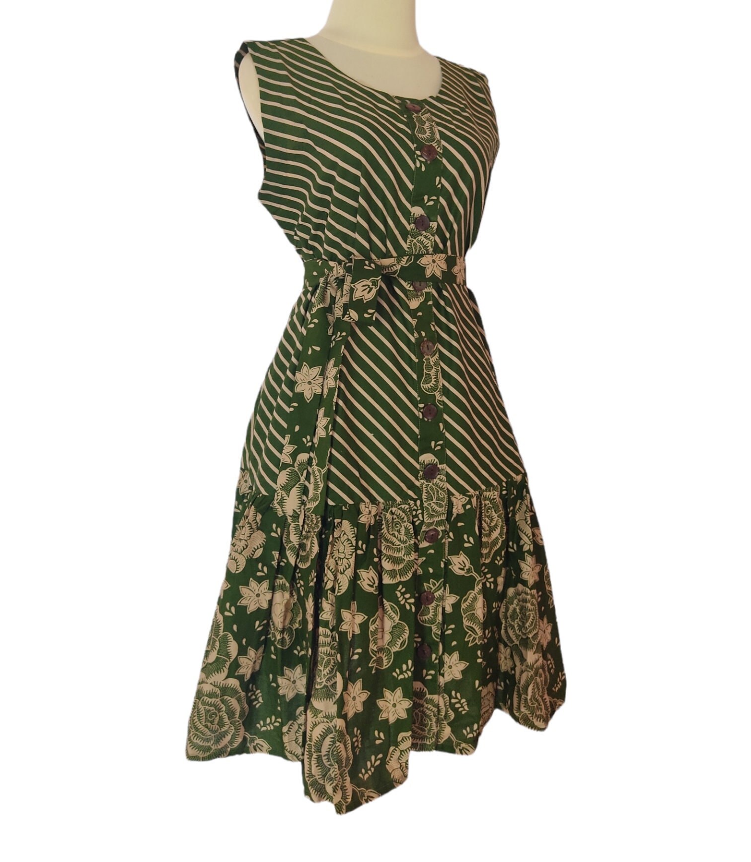 Green sleeveless batik dress for women, featuring a vibrant traditional pattern.
