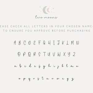 May include: A cream-colored background with the words "two moons" and a script of the alphabet in both uppercase and lowercase. The text "PLEASE CHECK ALL LETTERS IN YOUR CHOSEN NAME(S) TO ENSURE YOU APPROVE BEFORE PURCHASING" is also present.