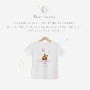 May include: White t-shirt with a bear graphic holding a balloon. The shirt has the text "Happy Father's Day Daddy" and the shop name "Two Moons".