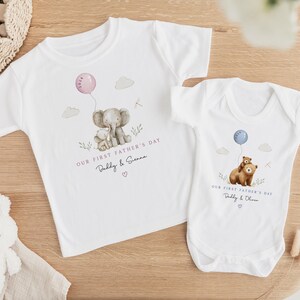 May include: White t-shirts and a onesie with watercolor illustrations. One shirt features an elephant holding a balloon, the text "OUR FIRST FATHER'S DAY Daddy & Sienna". The onesie has a bear with a balloon, text "OUR FIRST FATHER'S DAY Daddy & Oliver".