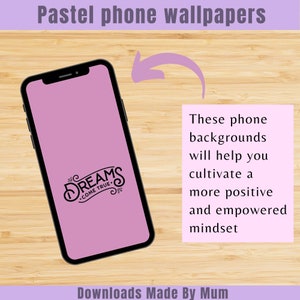May include: A smartphone with a black frame displays a pastel purple wallpaper with the words "DREAMS COME TRUE" in a decorative font. The image includes text that reads "Pastel phone wallpapers" and "Downloads Made By Mum."