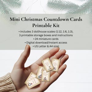 May include: Mini Christmas Countdown Cards Printable Kit. The image shows a hand holding several small cards with Christmas-themed illustrations and text. The cards are part of a printable kit, including dollhouse scales, storage boxes, and instructions. The text on the cards includes phrases like "Make hot cocoa" and "Watch a holiday movie."