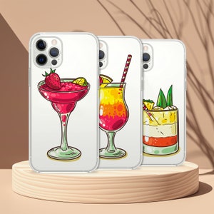 May include: Three clear phone cases with colorful illustrations of cocktails. The first case features a red margarita with a strawberry garnish. The second case features a yellow and red cocktail with a straw. The third case features a layered cocktail with a pineapple garnish.