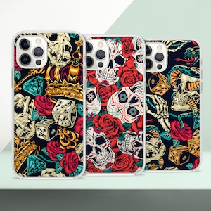 May include: Three phone cases with different colorful designs featuring skulls, flowers, dice, and snakes. The cases are clear and show the phone screen through the back.