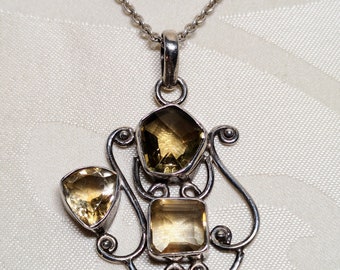 Intricate vintage sterling silver pendant set with 3 citrine gemstones