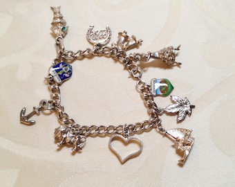 Vintage sterling silver charm bracelet with 11 silver charms