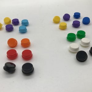 May include: Assortment of colorful round plastic buttons in various colors including yellow, orange, red, green, blue, purple, black, and white.