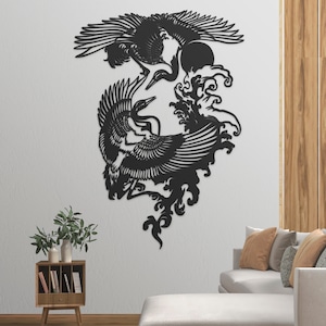 May include: Black metal wall art featuring two cranes in flight, surrounded by stylized waves. The art is mounted on a white wall in a living room setting.