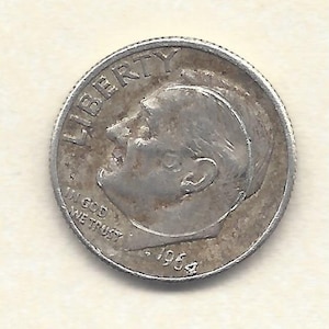 May include: A silver 1964 United States dime. The coin features a profile of a person and the word "LIBERTY" at the top. The words "IN GOD WE TRUST" are also visible. The year "1964" is at the bottom of the coin.