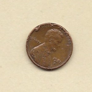 May include: A copper-coloured United States penny from 1981. The coin features a profile of a person and the word "LIBERTY". The coin shows signs of wear and tear.