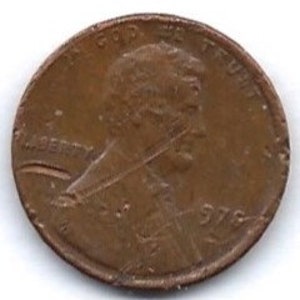 May include: A close-up of a copper-coloured penny. The coin features a profile of a man, the word "LIBERTY", and the year "1976". The coin shows signs of wear and tear.