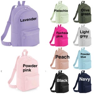 May include: A collection of ten backpacks in various colors including lavender, pistachio, olive green, fuchsia pink, light grey, powder pink, peach, powder blue, black, and navy. Each backpack features a main zippered compartment and a front pocket.
