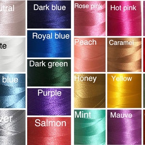 May include: A grid of thirty-two spools of thread in various colors, each labeled with its corresponding color name including green, neutral, dark blue, rose pink, hot pink, pink, pale pink, dusty rose, white, royal blue, peach, caramel, red, turquoise, light blue, pale blue, dark green, honey, yellow, pale green, lavender, olive, purple, mint, mauve, orange, mustard, black, silver, and salmon.