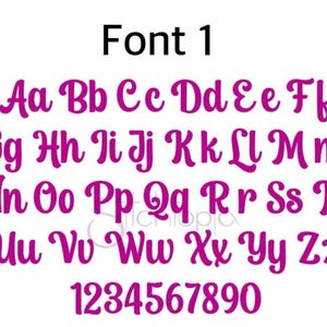 May include: A digital display of Font 1 featuring the full alphabet in uppercase and lowercase letters, along with the numbers 0 through 9. The characters are rendered in a bold, magenta, cursive script style against a plain white background.