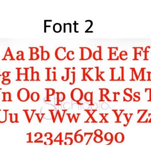 May include: A digital graphic display labeled Font 2, featuring the complete English alphabet in both uppercase and lowercase letters, followed by the numerals 0 through 9. All characters are rendered in a bold, red, serif typeface.