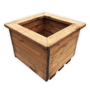 May include: A square wooden planter box made from reclaimed wood. The planter has a natural wood finish and is ideal for adding a rustic touch to your garden.