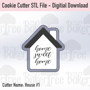 May include: A gray cookie cutter in the shape of a house with the text "home sweet home" inside. The cutter is designed for making cookies.