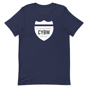 May include: Navy blue t-shirt with a white graphic of a road sign that says "CALGARY/SPRINGBANK CYBW ELEV 3940'"